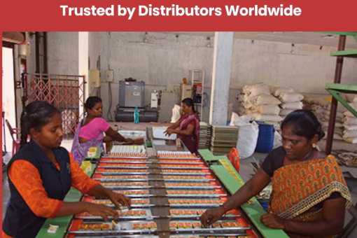 Women in a factory setting pack safety matches into boxes on a large green table. The environment is industrious, conveying teamwork and efficiency.